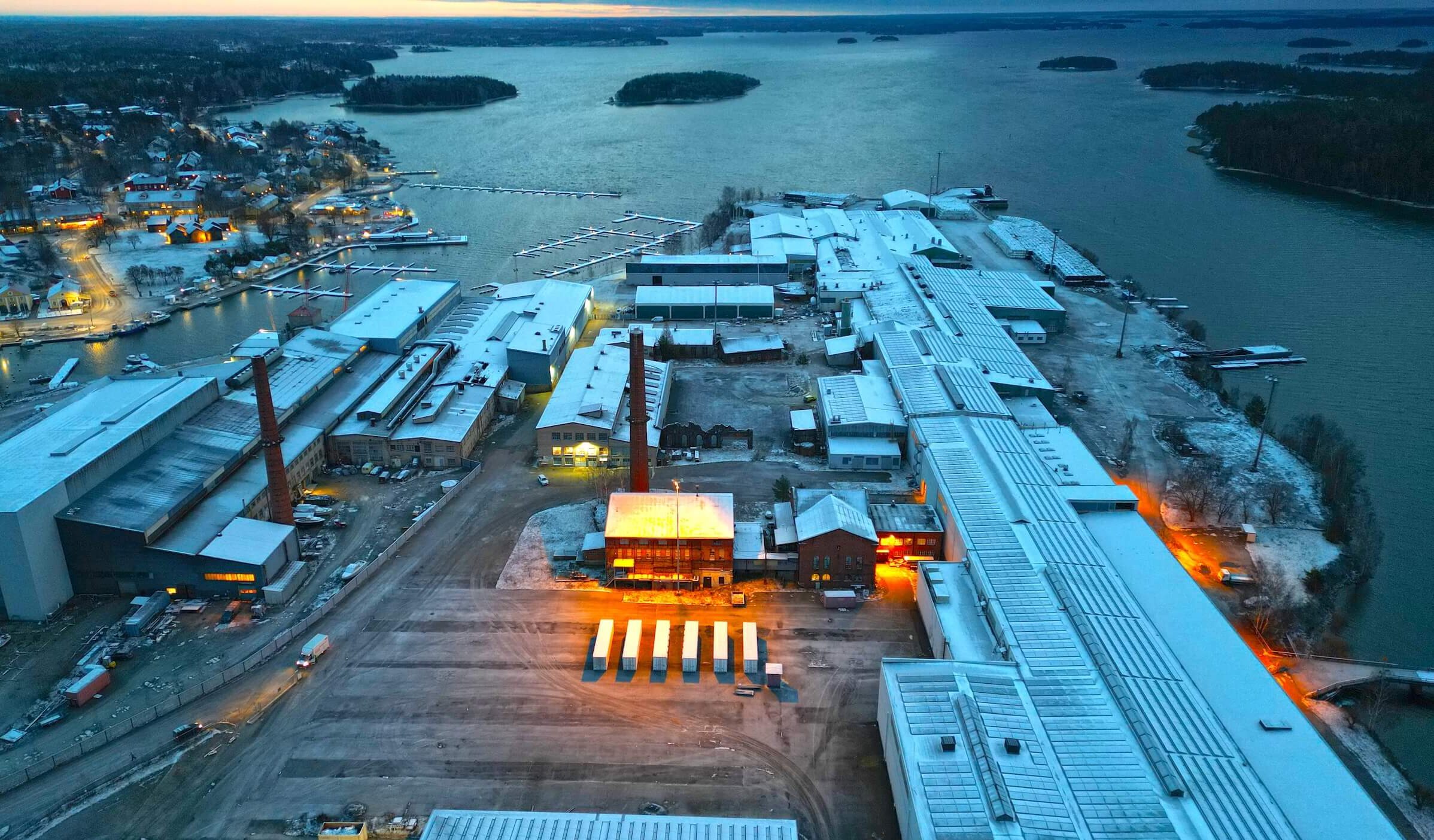 Archived aerial site view in Southern Finland, with industrial buildings, coastline and evening light.